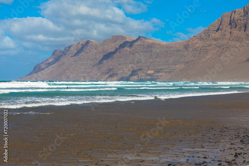The beach Playa de la Caleta de Famara is located in the northwest of the popular Canary Islands holiday island of Lanzarote, Spain. Famous surfing beach. 