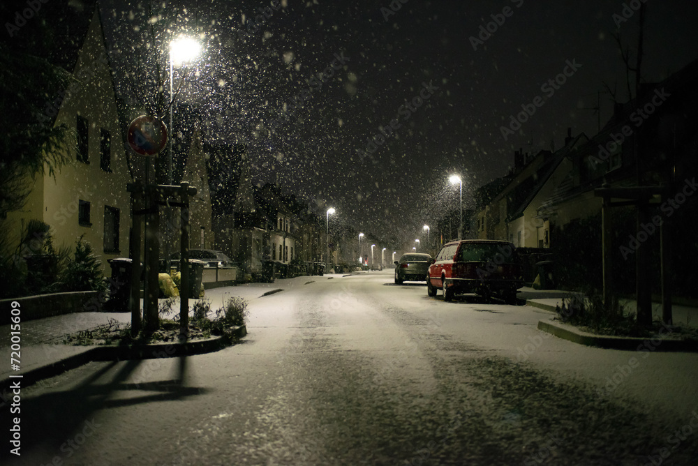 Blurred background. City view, lights, falling snow, night, street, bokeh spots moving cars winter scenery Lantern light