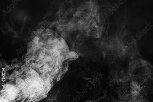 Blur white water vapour on isolated black background. Abstract of steam with copy space. Smoke on black background. Steam flow.