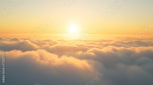 Sunrise over a sea of fluffy white clouds.