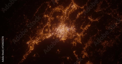 Hiroshima (Japan) aerial view at night. Top view on modern city with glow effect. Camera is zooming out, rotating counterclockwise photo