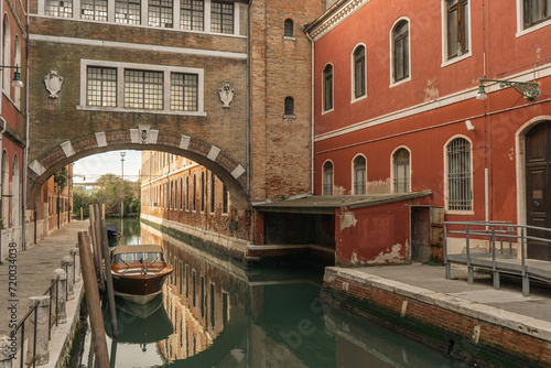 Channel in Venice - boat and pedway photo