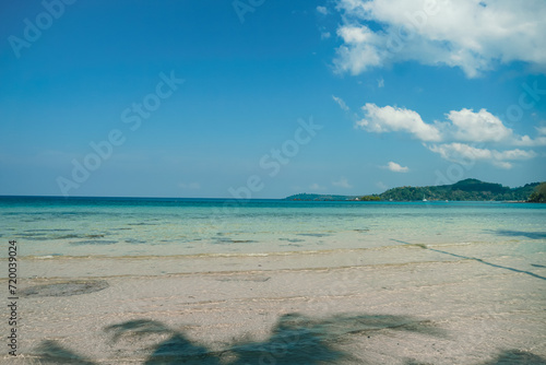 Tropical beach at Koh Kood  Thailand. turquoise sea water  ocean wave  yellow sand  green palms  sun blue sky  white clouds  beautiful seascape  summer holidays  exotic island vacation.