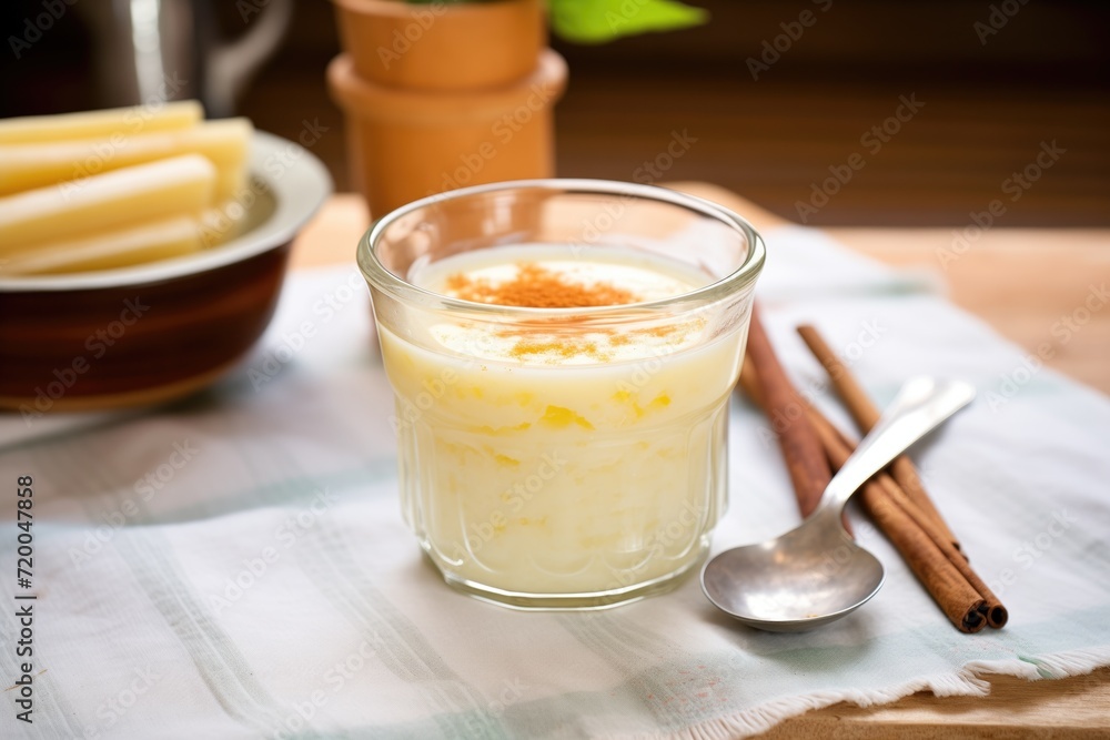 rice pudding drink in a glass cup, fresh vanilla pod alongside rice pudding drink in a glass cup, fresh vanilla pod alongside