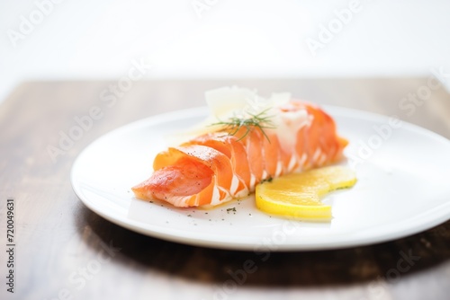 poached lobster tail with drawn butter on white plate