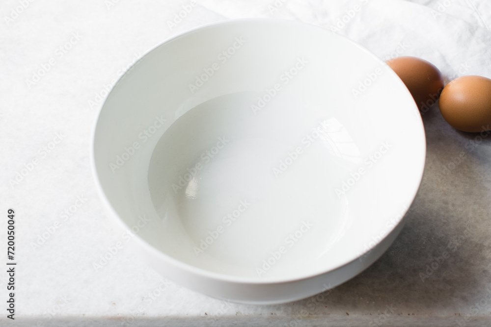 ceramic bowl on a marble table, white ceramic mixing bowl ceramic bowl on a marble table, white ceramic mixing bowl