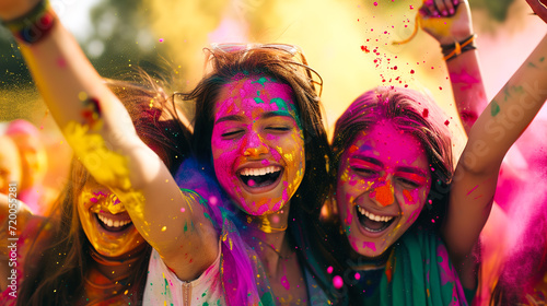 A group of friends in colorful attire celebrating Holi with bright gulal powder