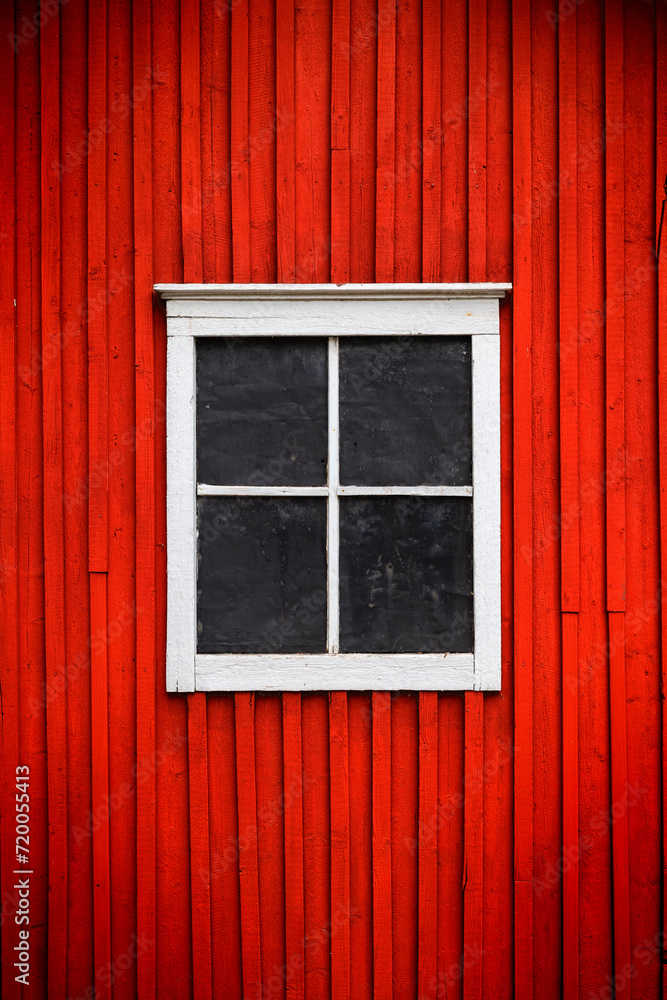 White window on red wooden wall. Traditional Finnish Architecture.