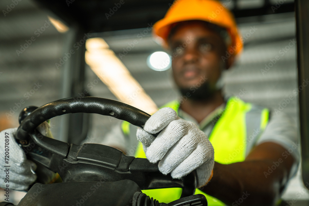 Happy African American male engineer driving and operating on a ...