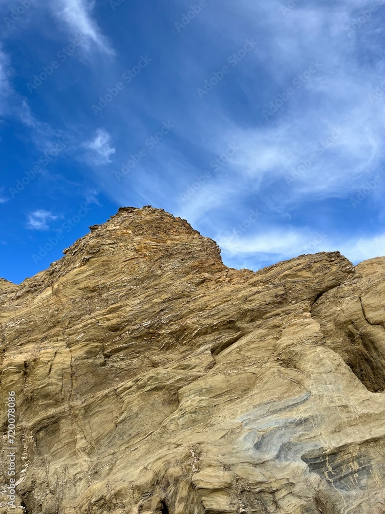 Fototapeta premium sandstone rock in the blue sky background, ocean rocky coast