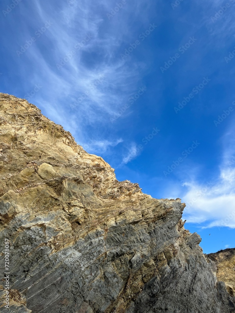 sandstone rock in the blue sky background, ocean rocky coast