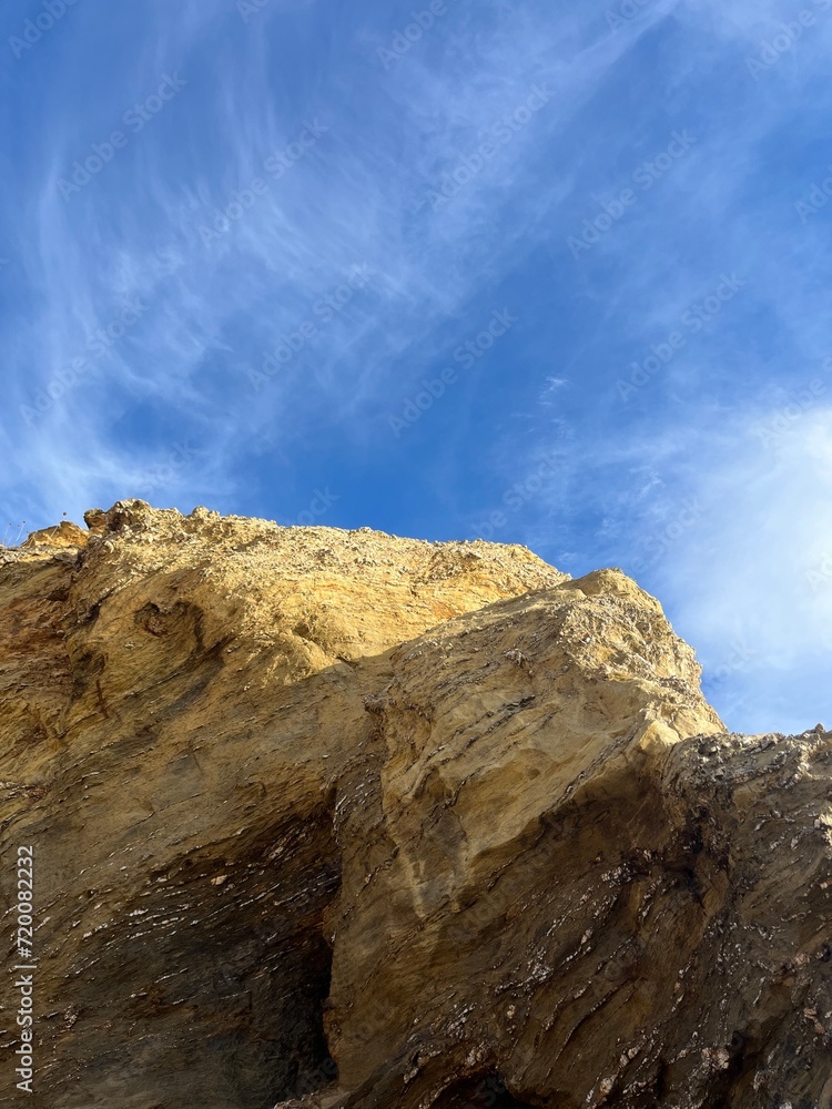 sandstone rock in the blue sky background, ocean rocky coast