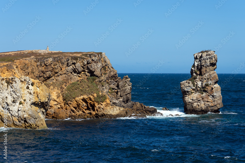 Rock formations of the Papoa island in the site of geological interest of the cliffs of the Peniche peninsula, portugal, in a sunny day.