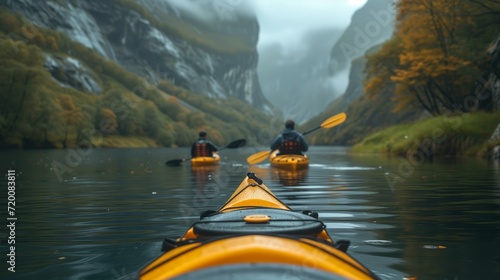 Kayakers navigating a tranquil lake surrounded by autumnal mountains.  © Javier