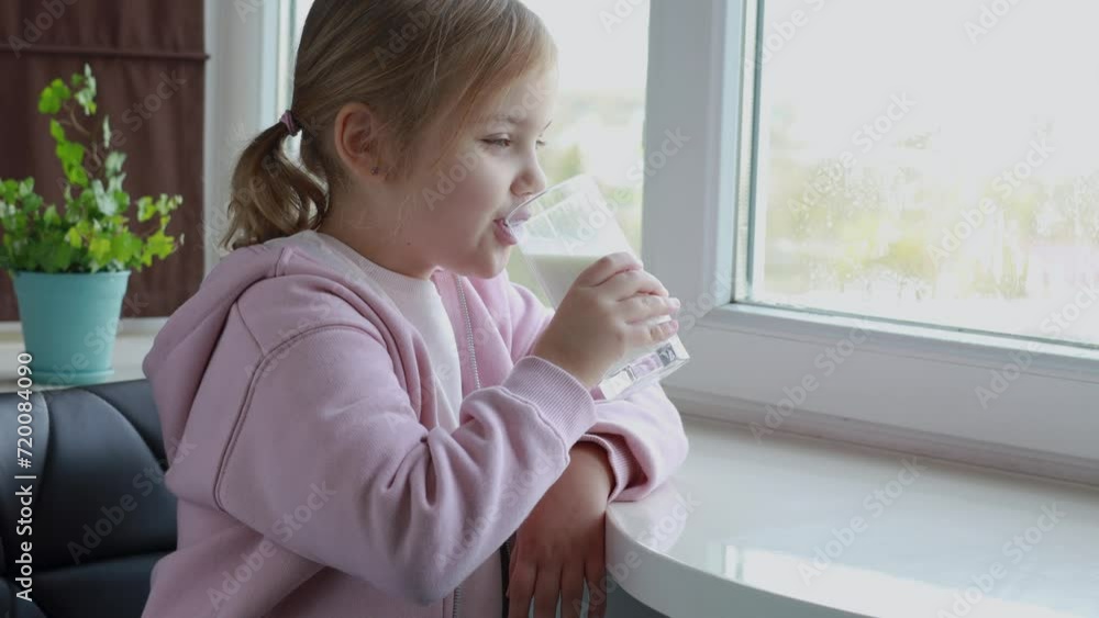 Child drinking milk,caucasian girl with a glass of dairy product Child drinking milk,caucasian girl with a glass of dairy product