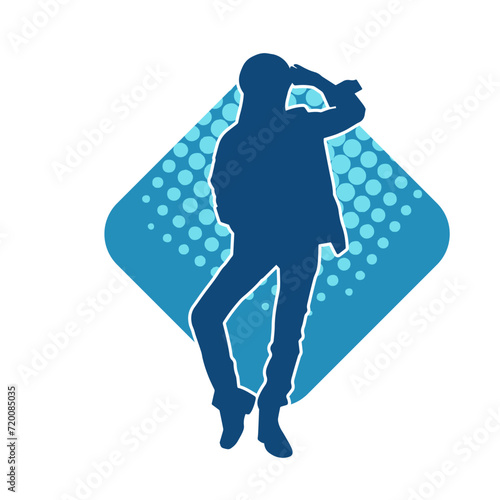 Silhouette of a slim female in dance pose. Silhouette of a woman dancing. photo