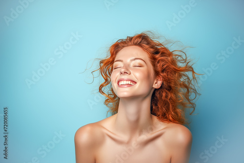 Portrait of a happy woman with ginger hair and flawless skin. Skin care concept.