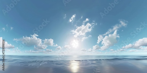 The sea with waves crashing on the shore. The waves are crashing against the sand  and the sun is shining through the clouds. The sky is blue and sunny  and there are white clouds in the sky