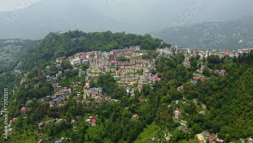 Aerial view of the cloudy day in gangtok city capital of sikkim state.A cable car riding towards station at the town center of gangtok, sikkim. photo