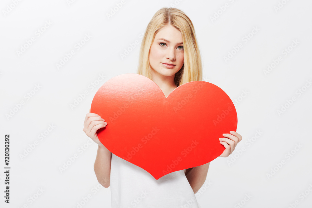 Woman, portrait and heart or poster mockup or Valentines message, announcement or bulletin. Female person, model and face or white background in studio as love gesture or billboard, placard or banner Woman, portrait and heart or poster mockup or Valentines message, announcement or bulletin. Female person, model and face or white background in studio as love gesture or billboard, placard or banner