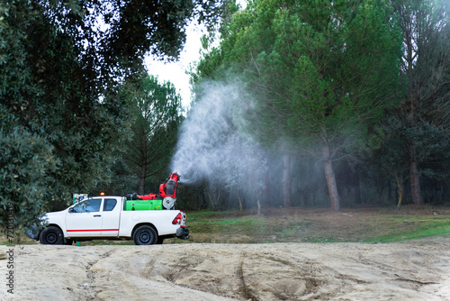 vehicle spraying a pine grove against the caterpillar pine processionary (Thaumetopoea pityocampa) photo