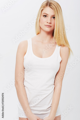 Portrait, tank top or woman with beauty, underwear or confidence and healthy body on white background. Face, female person or model with wellness and natural glow with skincare or aesthetic in studio