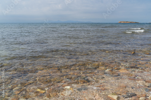 Rocky shore of the Myrto Sea in Greece  clear water.