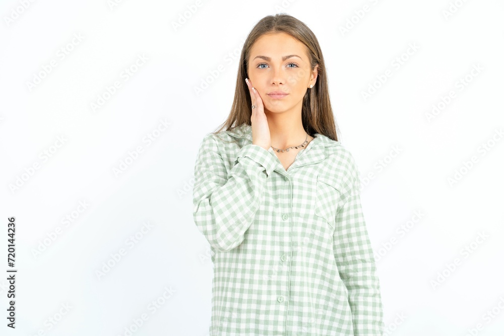 Photo of Beautiful young woman wearing green plaid pyjama enjoy fresh perfect smooth skin touch face Photo of Beautiful young woman wearing green plaid pyjama enjoy fresh perfect smooth skin touch face