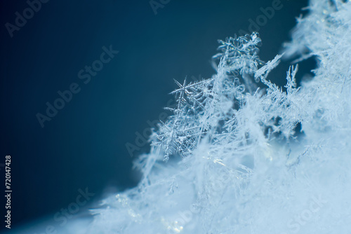 Snowflakes closeup, snowy background. Winter