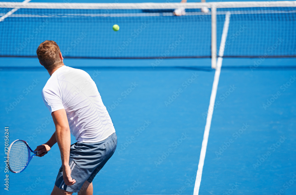 Sport, man and tennis on court with serve, competition and performance outdoor with fitness and energy. Athlete, player and ball on turf for training, exercise and racket with skill, game and hobby