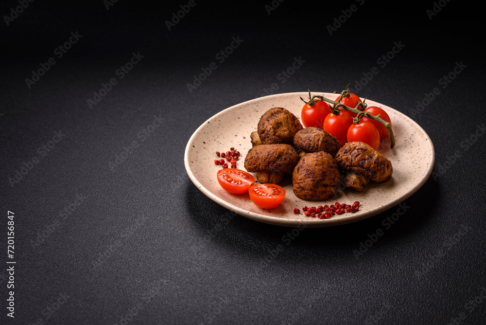 Delicious juicy whole champignons baked on the grill with salt and spices Delicious juicy whole champignons baked on the grill with salt and spices