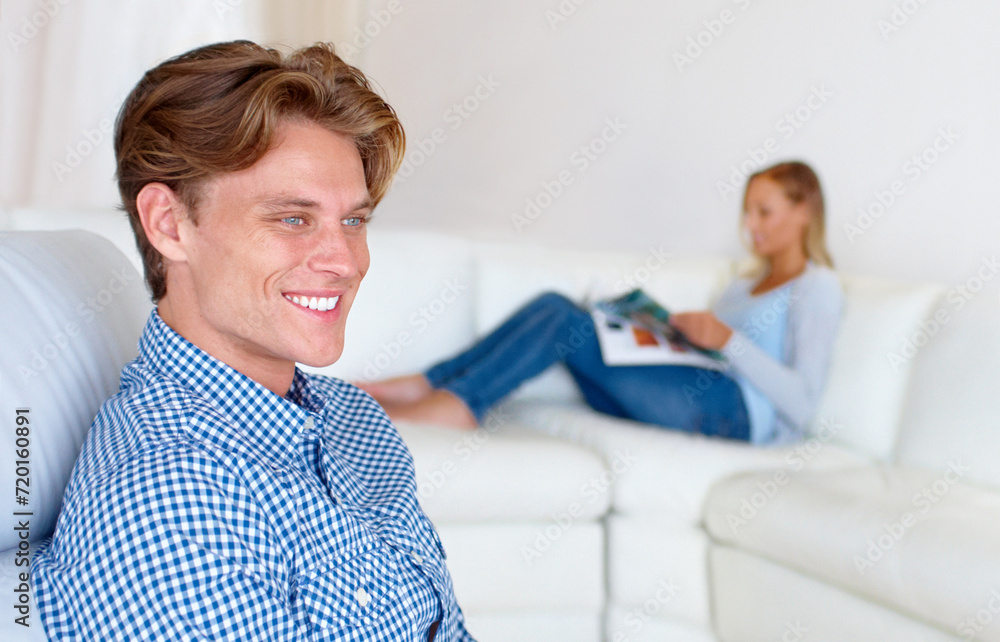 Fototapeta premium Relax, happy and couple on sofa in home for bonding, healthy relationship and calm in living room. Lounge, dating and man thinking, woman reading magazine and chill together in house or apartment