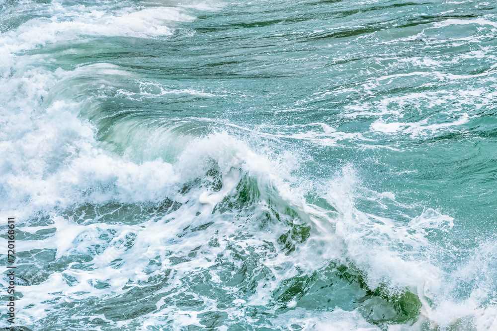 Wave splashing close-up. Crystal clear sea water, in the ocean in San Francisco Bay, blue water, pastel colors.