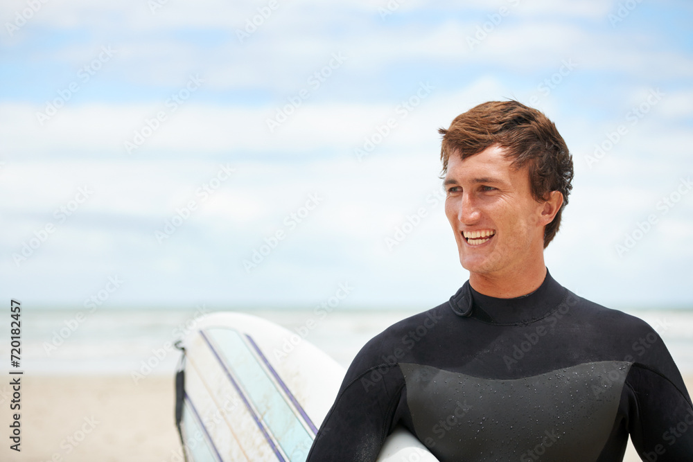 Surfing, happy and man with surfboard on beach for water sports training, freedom and fitness outdoors. Nature, smile and person with mockup space for adventure on holiday, vacation and hobby by sea