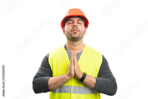 Builder holding hands as prayer gesture faithful concept photo