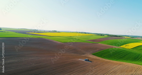 Agricultural - Tractor working in field.