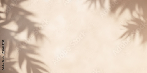 Beautiful texture of beige brown luxury  smooth stucco wall with soft foliage dappled light of tropical tree leaf shadow  