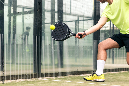 young man playing paddle tennis. close-up