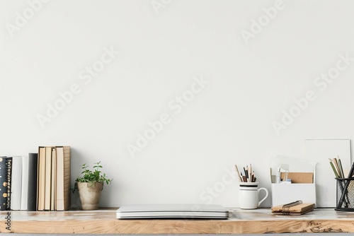 Workspace - office table, empty desk with books and supplies against the white wall, copy space for text or product showcase
