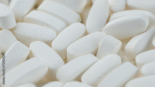 White medical pills close up. Pills and drugs. Production of pharmaceuticals and drugs, heap of tablets