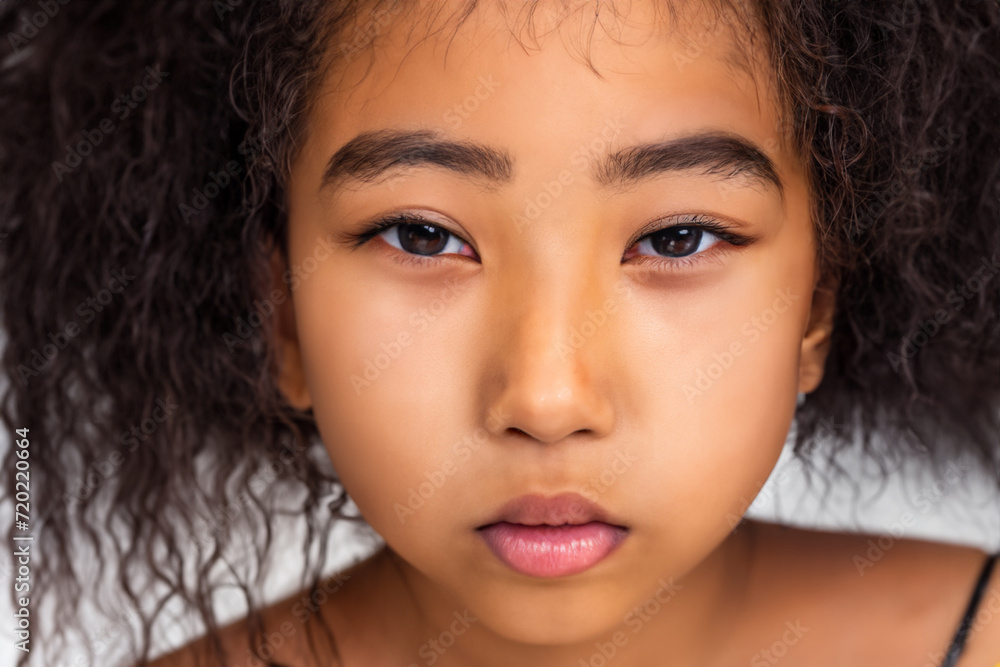 portrait of a girl. girl model with curly hair looks at the camera, white background. portrait beauty concept portrait of a girl. girl model with curly hair looks at the camera, white background. portrait beauty concept