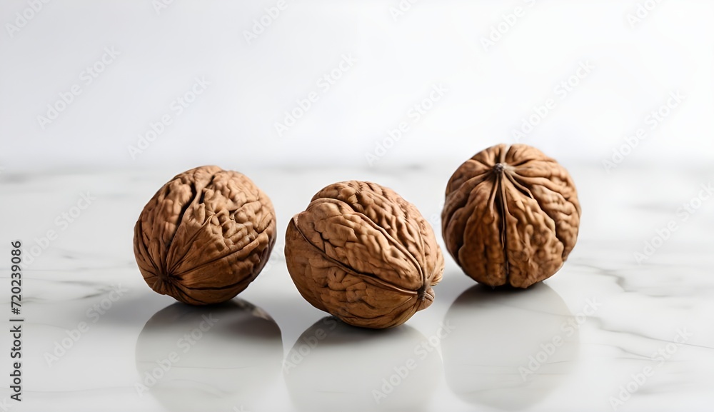 3 Walnuts on a white table and white background 3 Walnuts on a white table and white background