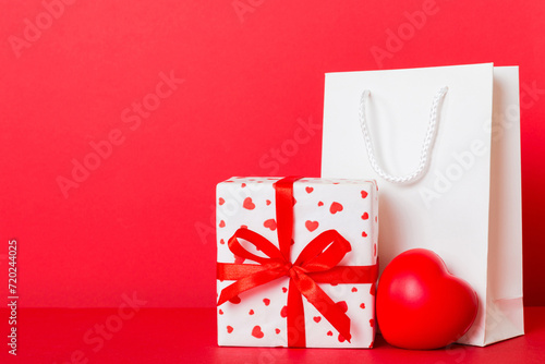 Shopping bag with gift box on colored background perspecrive view. Space for text holiday concept photo