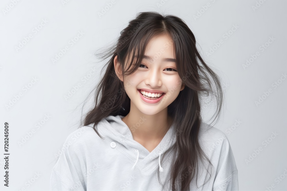 Asian girl with perfect skin and long, luxurious hair poses against a white backdrop, epitomizing beauty and simplicity. Generative AI. Asian girl with perfect skin and long, luxurious hair poses against a white backdrop, epitomizing beauty and simplicity. Generative AI.