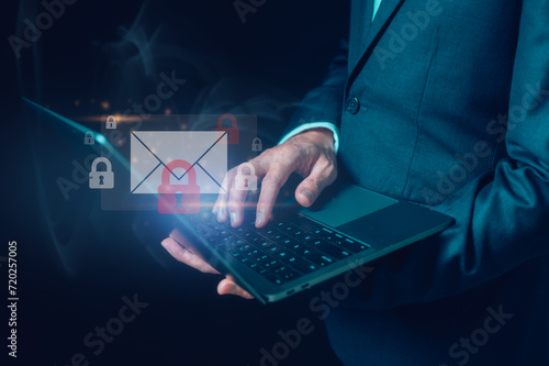 Fototapeta Naklejka Na Ścianę i Meble -  email online security concept Businessman holding icon email and padlocks show cybersecurity and privacy to protect personal data from scammer