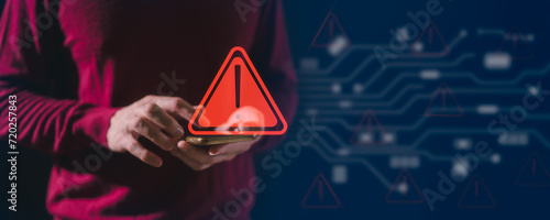 man using mobile phone with red triangle caution warning sign for maintenance notification error and risk concept, privacy data security, risk management photo
