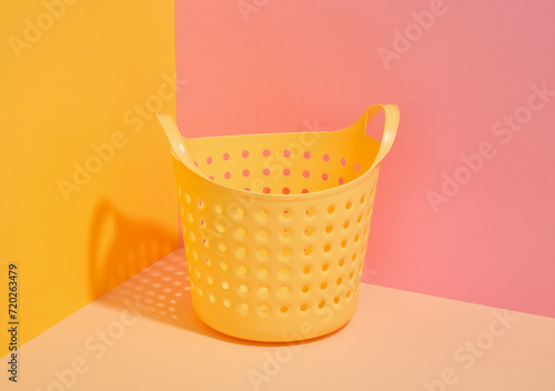 Yellow empty laundry basket. Used for storing dirty clothes.