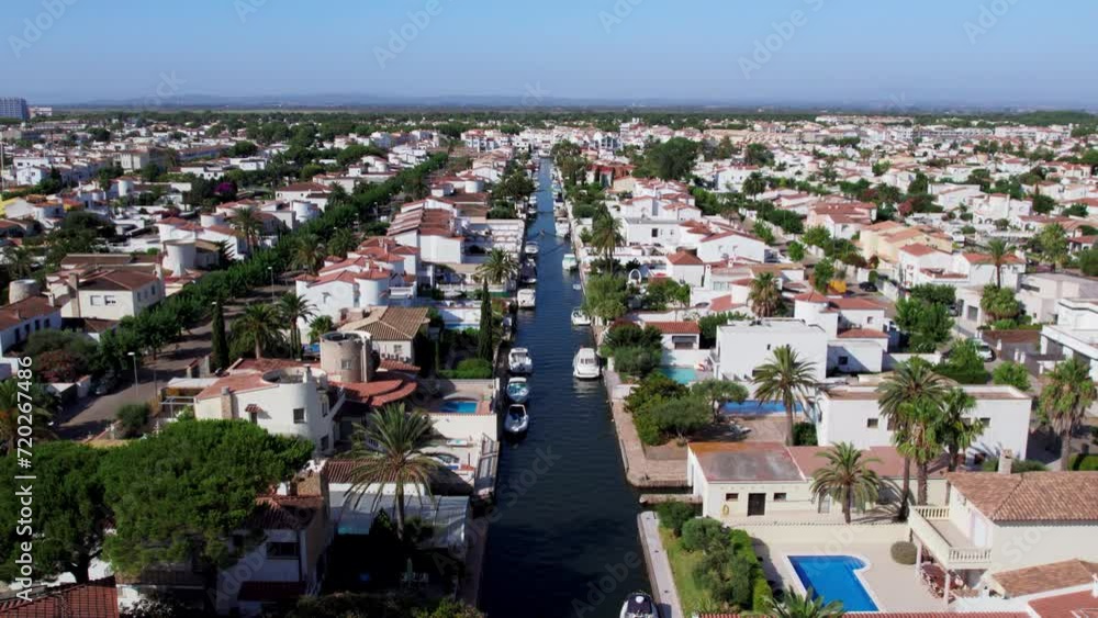 Aerial view of luxurious private community buildings in Empuriabrava. Exclusive holiday apartments or real estate for sale in Europe. Excursion on private boat. Tourist heaven destination. Aerial view of luxurious private community buildings in Empuriabrava. Exclusive holiday apartments or real estate for sale in Europe. Excursion on private boat. Tourist heaven destination.