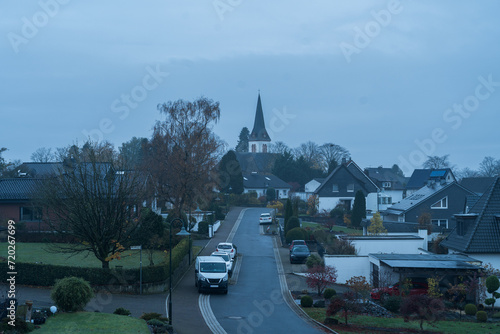 Obraz na płótnie Rainy autumn morning cityscape of german village Wermelskirchen in the Rheinisch-Bergischer Kreis, North Rhine-Westphalia, Germany, southeast of Remscheid. St. Michael church in the background. w salonie