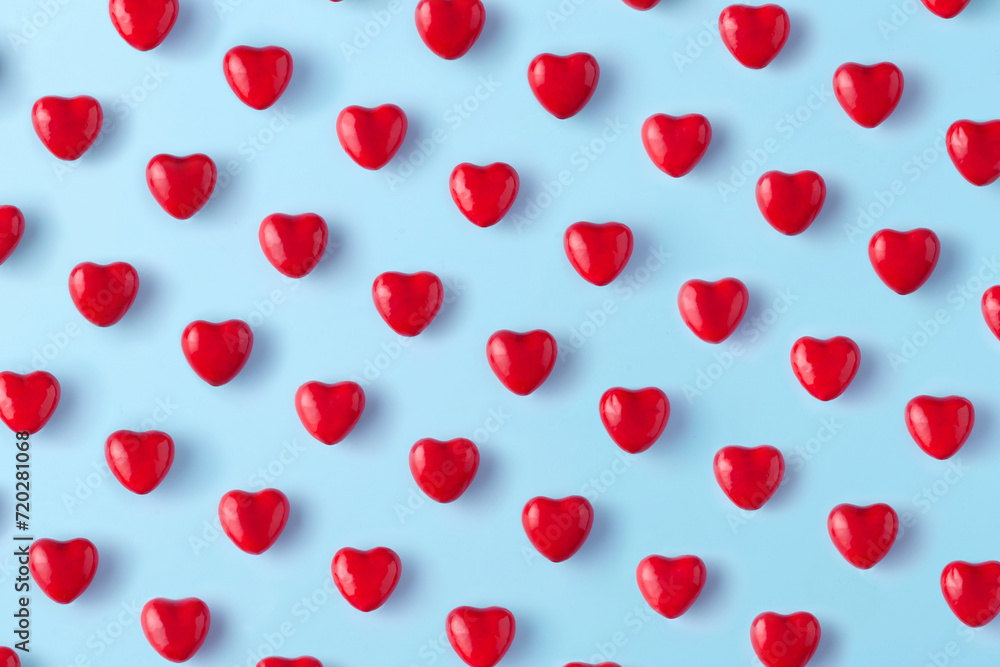 Red hearts pattern on blue background. Top view. Red hearts pattern on blue background. Top view.